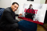 Harry Lennix signs.