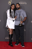 Codie Elaine Oliver and Tommy Oliver pose with their award for Exceptional Merit In Documentary Filmmaking for Going To Mars: The Nikki Giovanni Project backstage at the 76th Creative Arts Emmy Awards